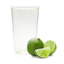 Classic lime Ranch Water in glass with whole lime and fresh lime wedges on white background.