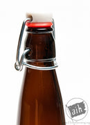 The neck of an E.Z. cap swing top beer bottle with the top closed.