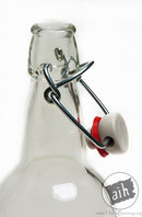 The neck of a clear E.Z. cap swing top beer bottle.