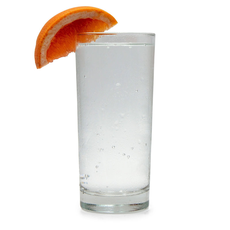 A chilled glass of Ruby Grapefruit Hard Seltzer with a grapefruit wedge on the side.