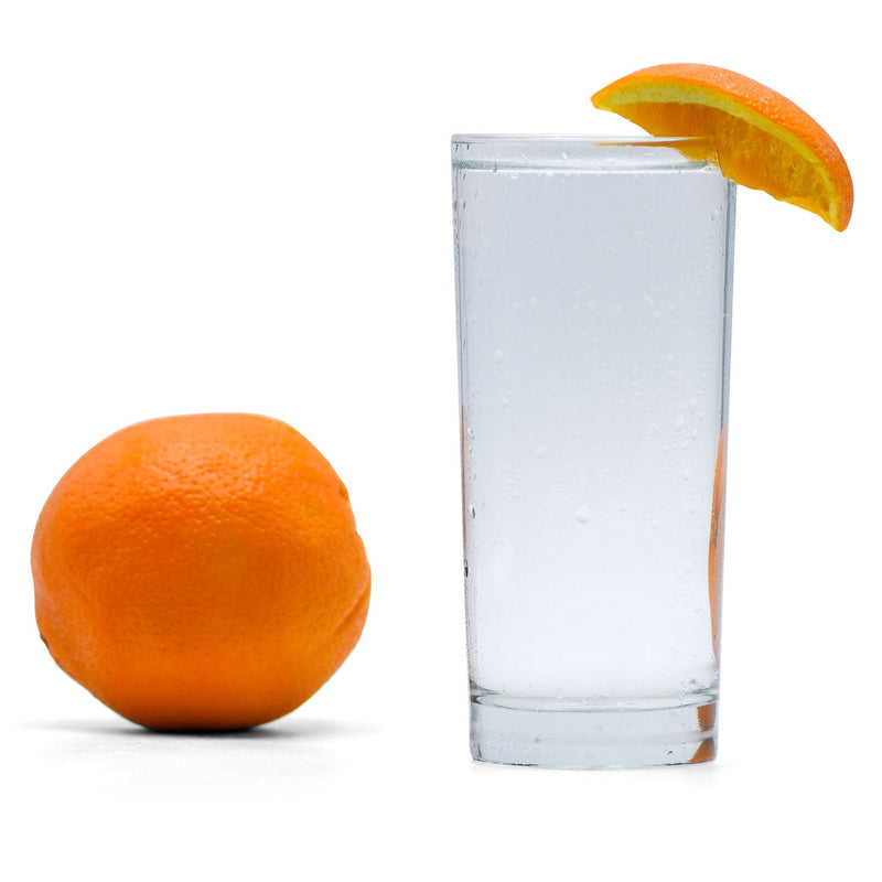 A refreshing glass of Navel Orange Hard Seltzer with an orange wedge beside it.