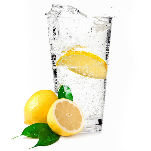 A zesty glass of Lemon Hard Seltzer with a lemon wedge next to it.