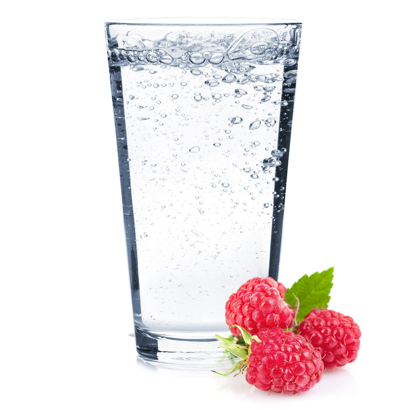 A tangy glass of Raspberry Hard Seltzer with ripe raspberries next to it.