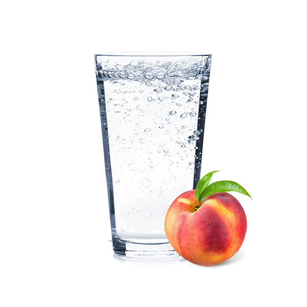 A juicy glass of Peach Hard Seltzer with peach slices next to it.