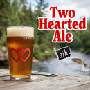Pint of beer with two hearts on a coaster outdoors,  text overlay for Two Hearted Ale