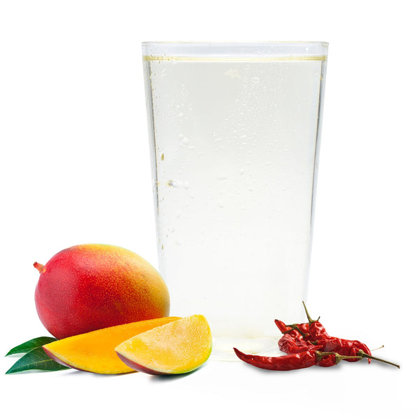 Bold mango Ranch Water with dried de árbol chiles and ripe mango slices in front of sparkling drink.