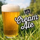Glass of cream ale in grass with 'Cream Ale' text